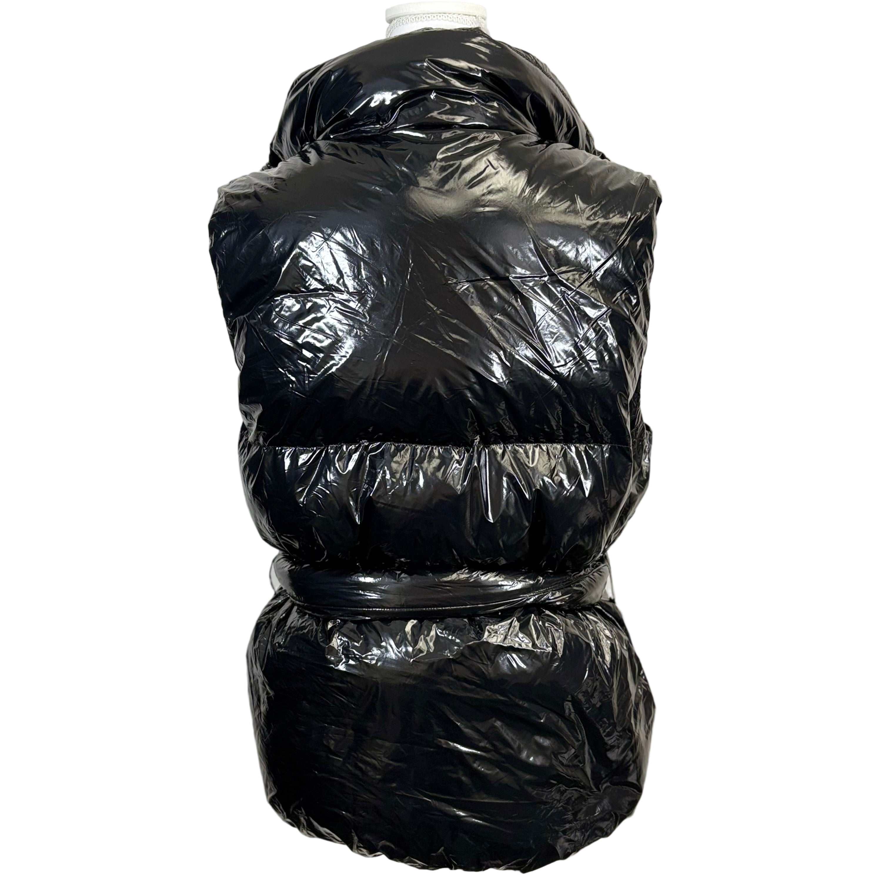 Black puffer vest on a mannequin against a white background