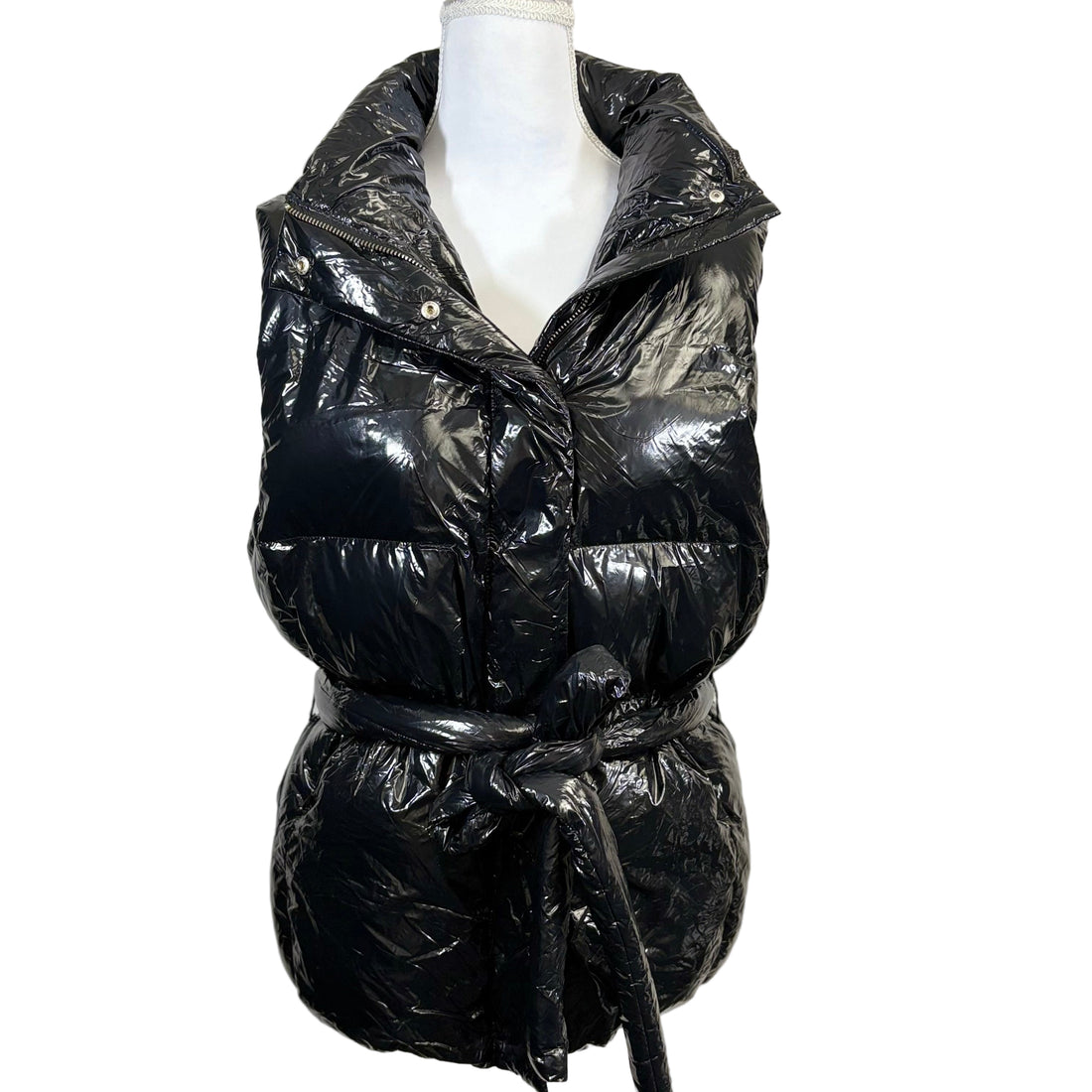 Black puffer vest on a mannequin against a white background