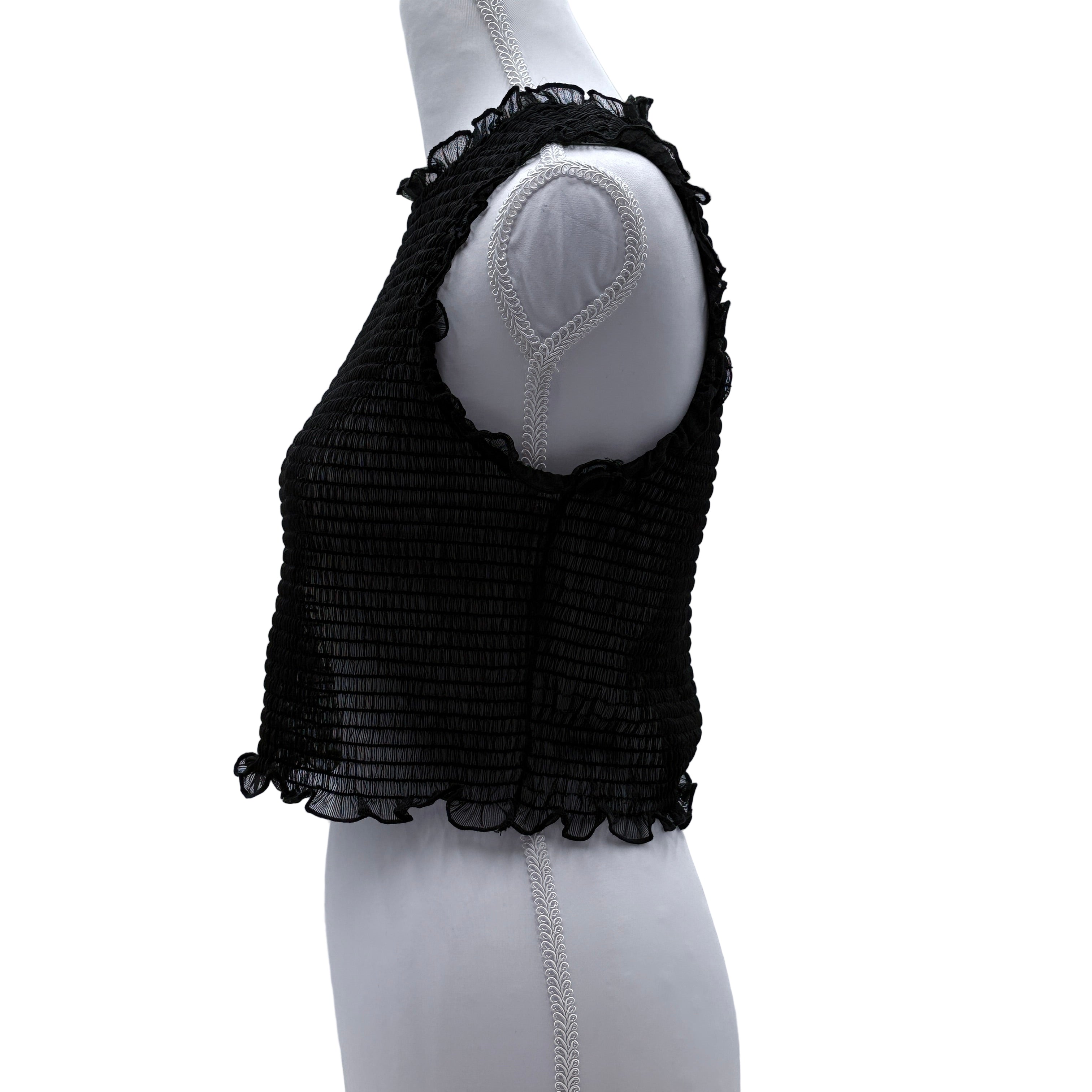 Black sheer textured sleeveless top on a mannequin against a white background